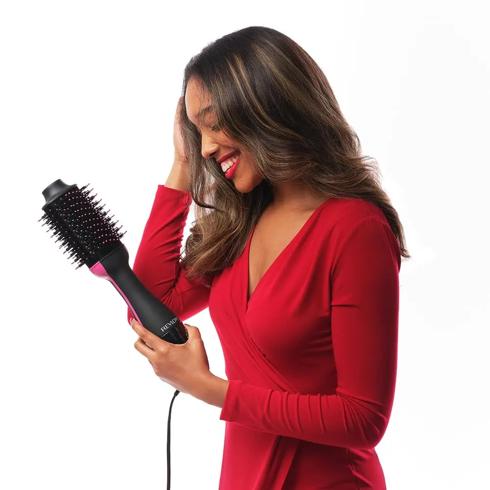 The Revlon One Step Hair Dryer and Volumizer styles, dries, and volumizes hair with less frizz, featuring a unique oval brush for smoothing and creating volume.