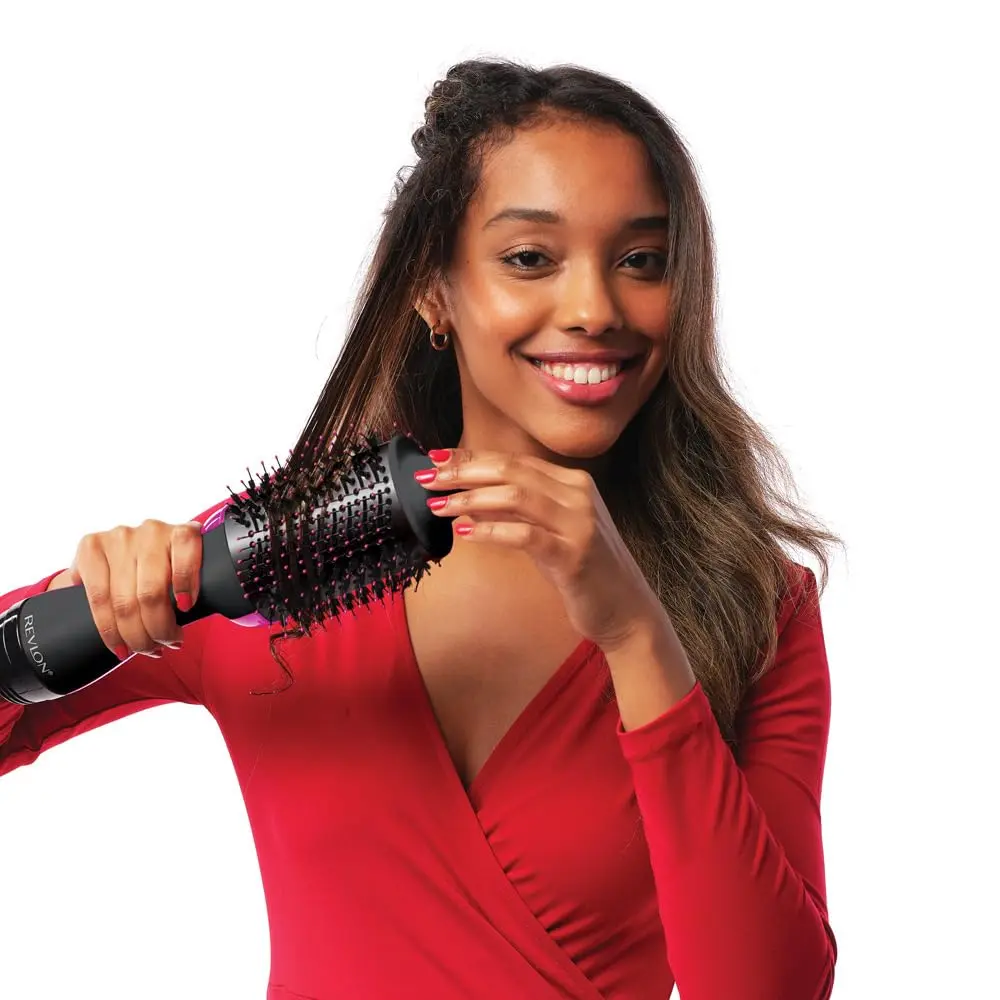 The Revlon One Step Hair Dryer and Volumizer styles, dries, and volumizes hair with less frizz, featuring a unique oval brush for smoothing and creating volume.
