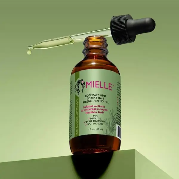 Mielle Organics rosemary mint hair growth oil infused with biotin and essential oils to stimulate hair follicles, promote hair growth, and hydrate the scalp, in a 2 fl oz bottle.