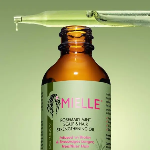 Mielle Organics rosemary mint hair growth oil infused with biotin and essential oils to stimulate hair follicles, promote hair growth, and hydrate the scalp, in a 2 fl oz bottle.