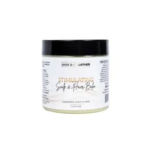 Bask & Lather scalp and hair balm moisturizes the scalp, supports hair growth, and adds shine with shea butter, rosemary oil, and vitamin E.