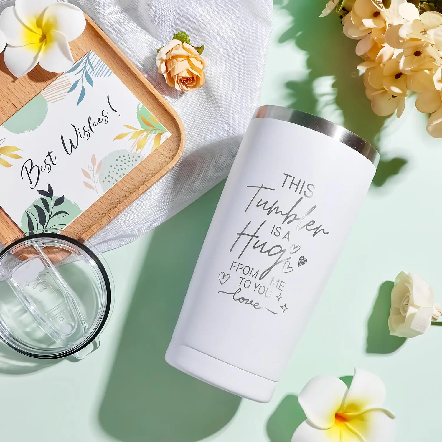 This self care gift basket for women includes a blanket, tumbler, candle, soap, bath bomb, jade roller set, eye mask, and socks.