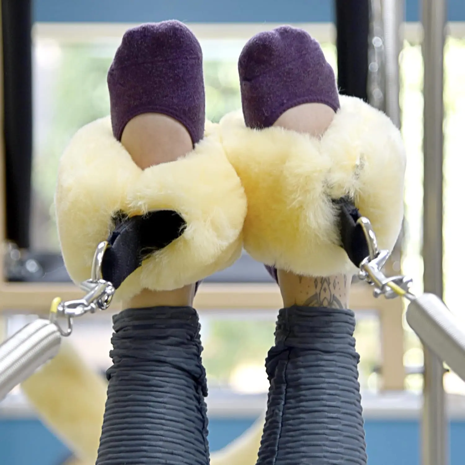 These sheepskin fuzzies add comfort to your Pilates reformer workout while protecting your hands and ankles from friction.