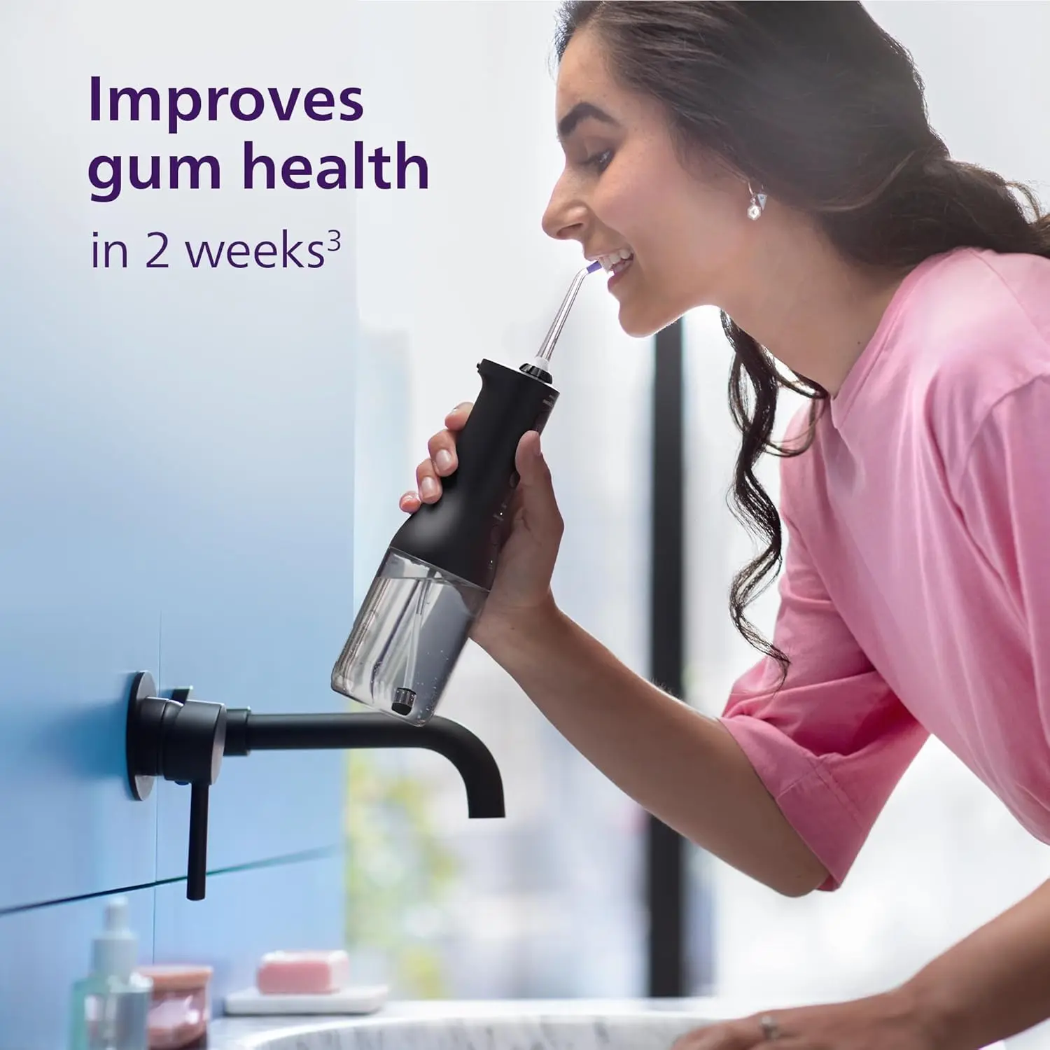 Black SONICARE cordless power flosser featuring quad stream technology for effective cleaning between teeth and along the gumline, complete with charging cable and nozzle attachments.