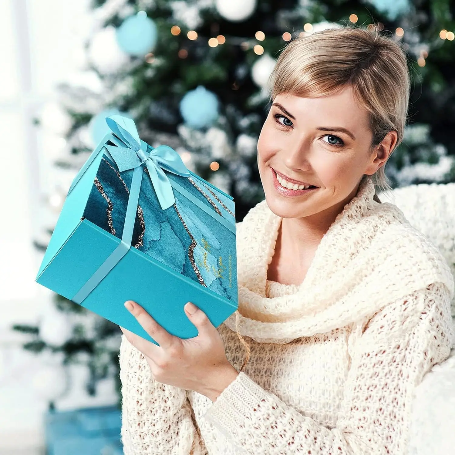 This luxury spa gift set for women includes a lavender bath bomb, handmade soap, bath salts, scented candle, eye mask, headband and greeting card, all arranged in a beautiful gift box.