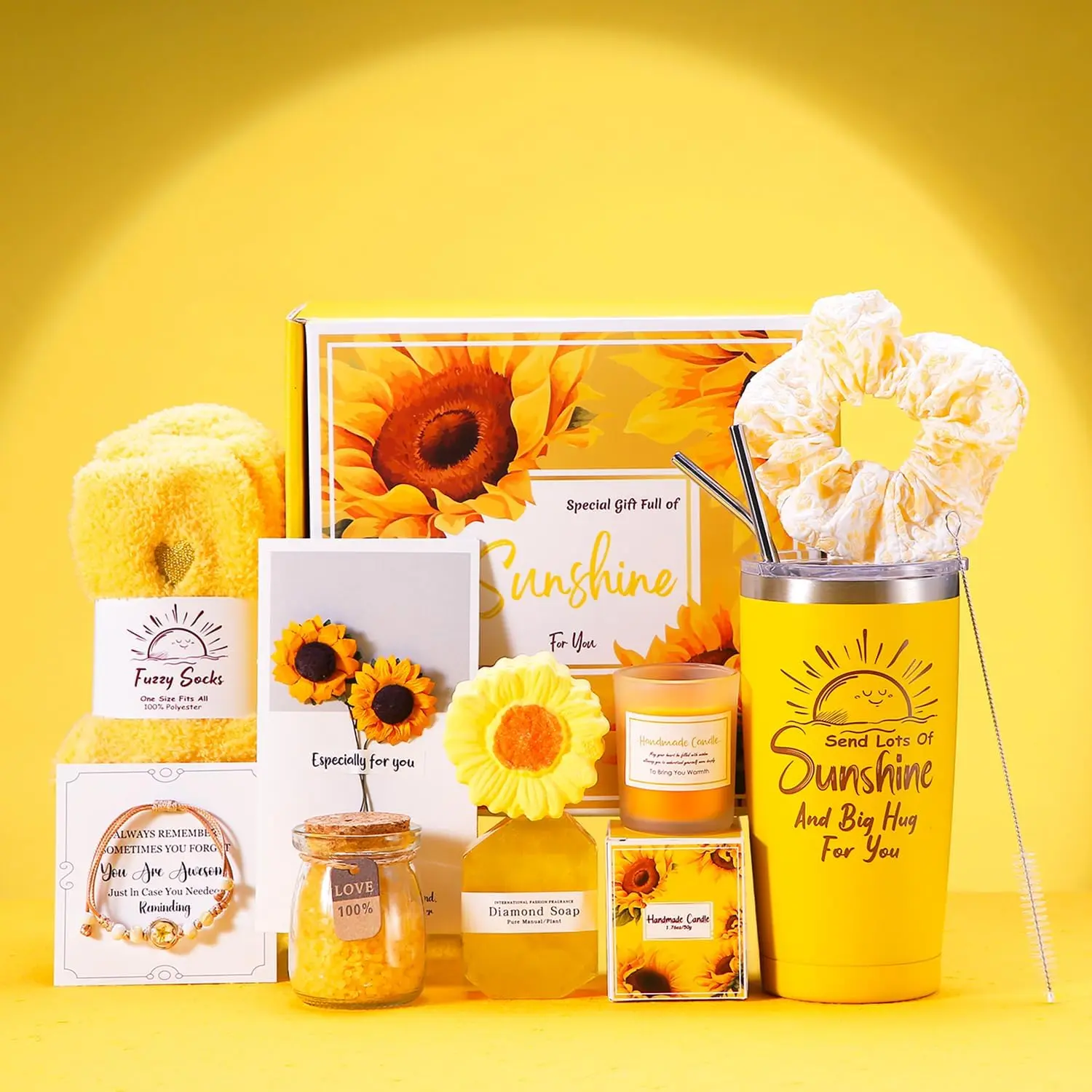 This spa gift set for women includes a sunflower-themed bath bomb, scented candle, tumbler, jewelry, and other self-care items in a beautifully packaged gift box.