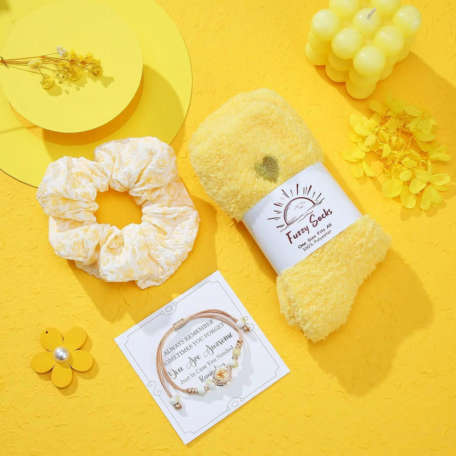 This spa gift set for women includes a sunflower-themed bath bomb, scented candle, tumbler, jewelry, and other self-care items in a beautifully packaged gift box.