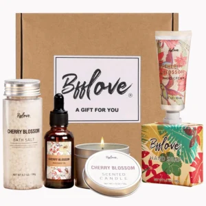 This 5-piece cherry blossom scented spa gift set for women includes massage oil, a scented candle, bath salt, hand cream, and soap, perfect for a relaxing self care experience.