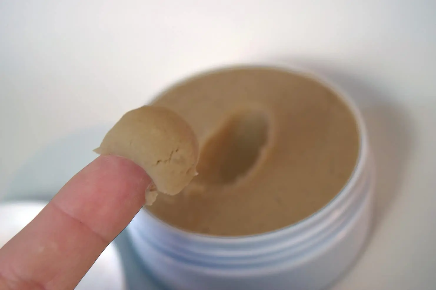 Small jar of SPF for scalp micropigmentation, designed to mattify and moisturize, with instructions to apply lotion first if the scalp is dry.