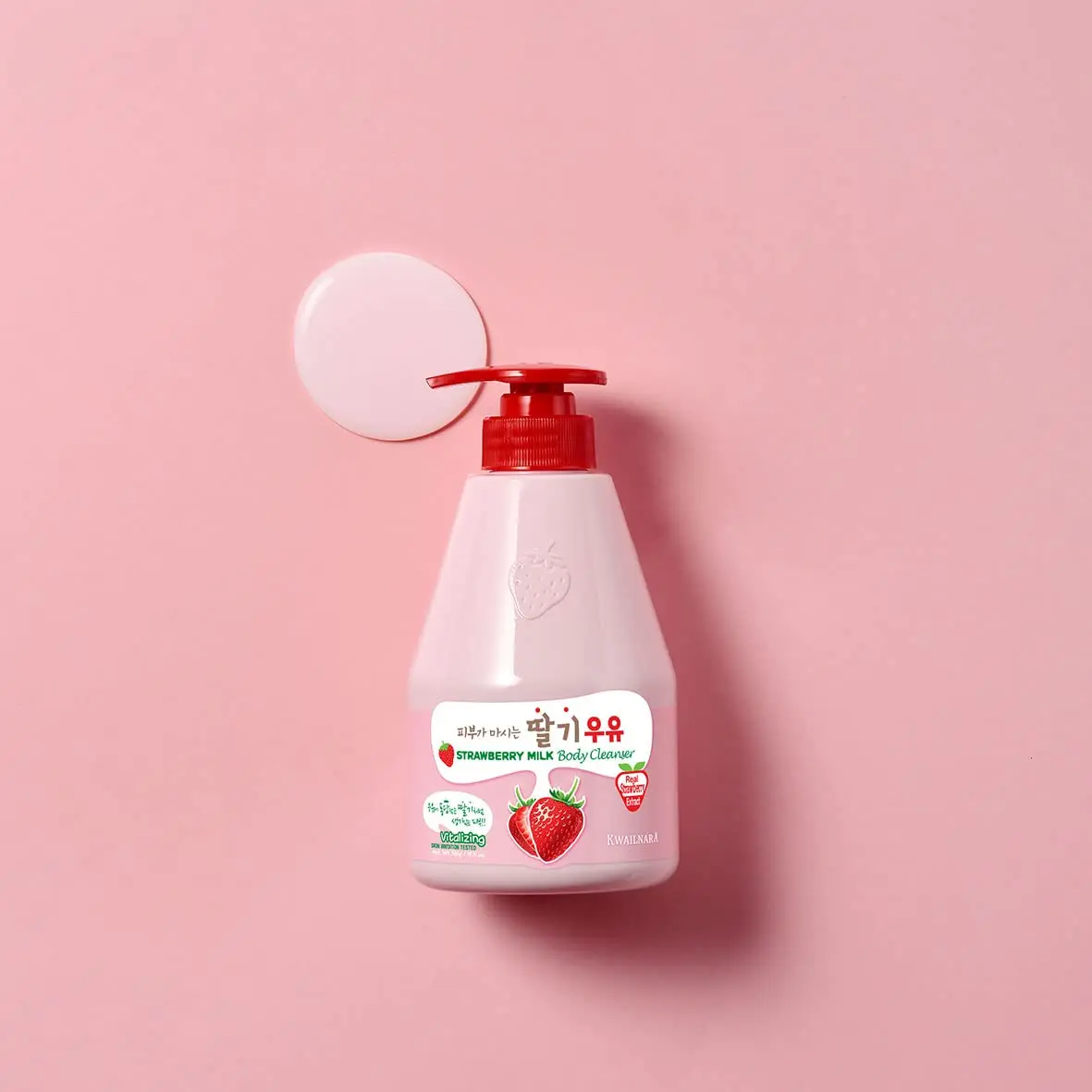 A bottle of KWAILNARA Strawberry Milk Body Cleanser by WELCOS, a creamy and fragrant cleanser for soft and moisturized skin.