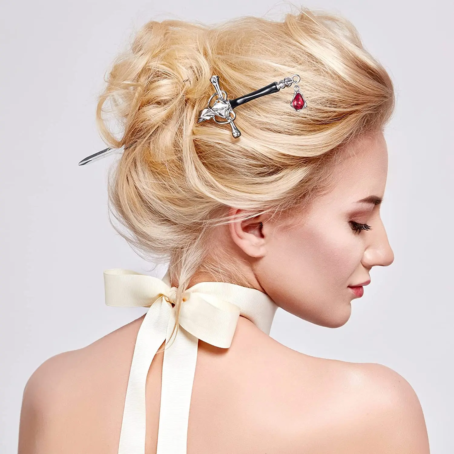 These sword hair pins feature an ancient Chinese style with delicate tassels and gem accents, perfect for styling women's buns in a gold and silver color.