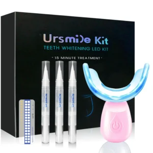 This pink teeth whitening kit includes an LED light, teeth whitening gel pens, a color plate, and a tray for sensitivity-free teeth whitening at home or while traveling.