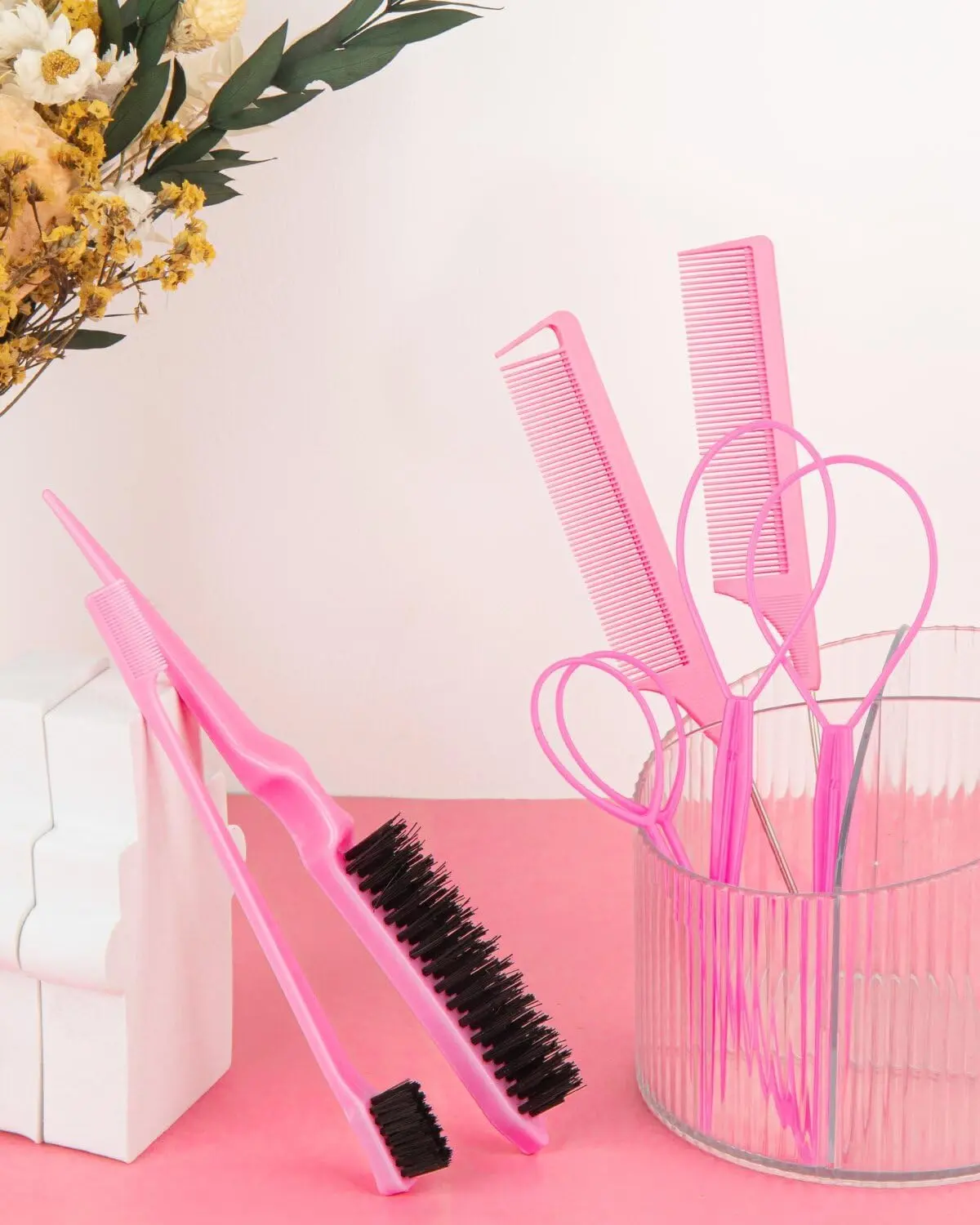 This 8-piece pink hair styling kit includes topsy tail tools, combs, and a double-sided edge brush for easy ponytails, braids, and sleek edges.
