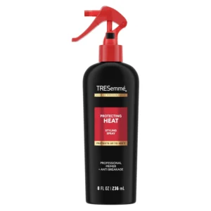 A bottle of TRESemmé Thermal Creations Heat Tamer Spray, a hair styling agent designed to protect hair from heat damage.