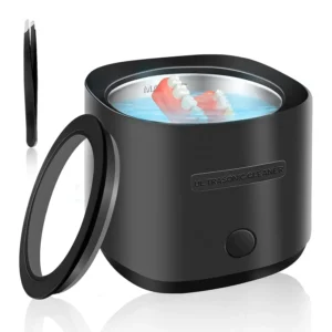 Black portable ultrasonic cleaner effectively removes particulates from dentures, retainers, aligners and mouthguards with 42kHz sound waves.