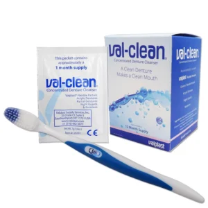 Val-Clean denture cleaning sachets and a blue silicone brush for cleaning Valplast flexible dentures and other dental appliances, providing a year's supply.