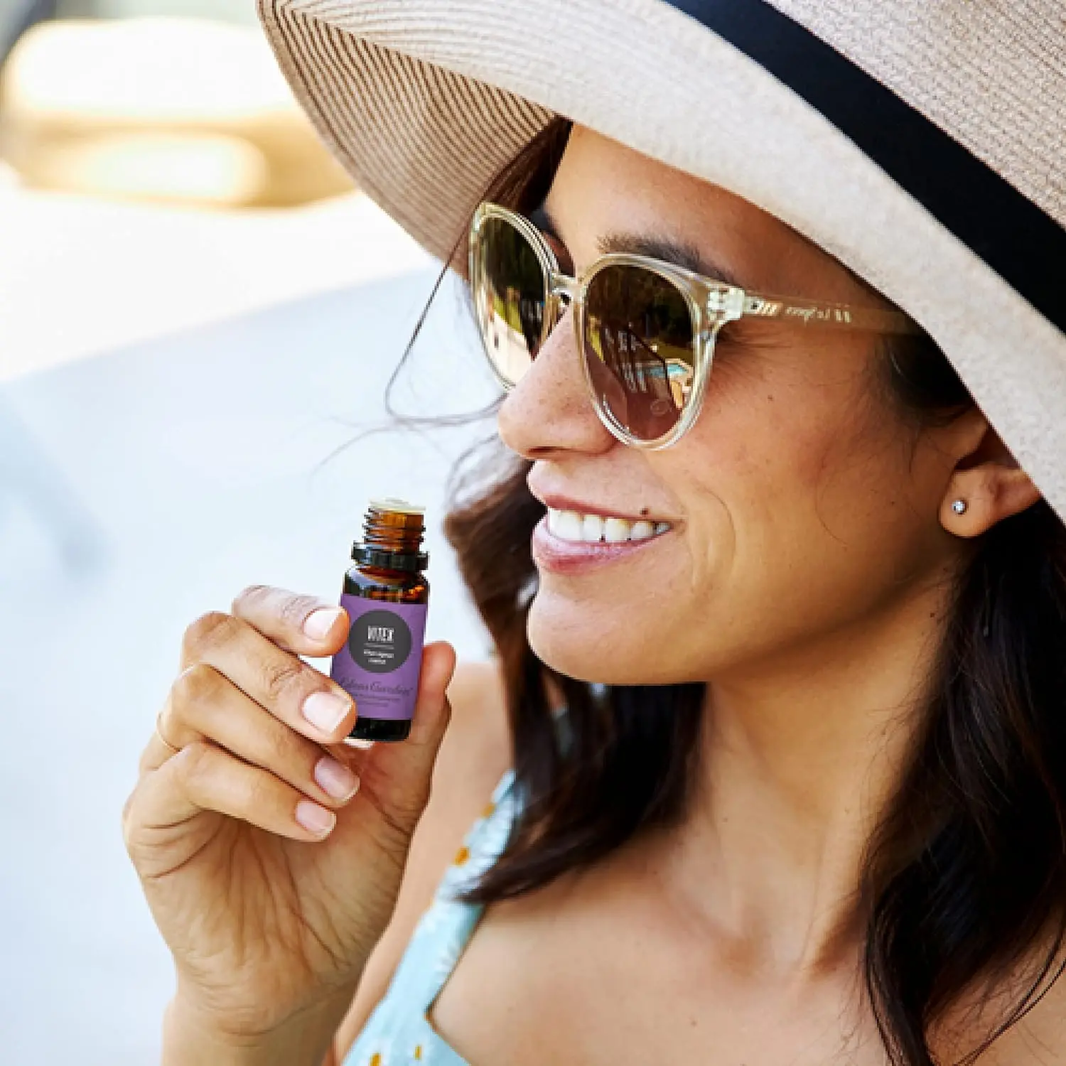 A bottle of Edens Garden Vitex essential oil, used to ease PMS symptoms and promote relaxation, sits on a white background.