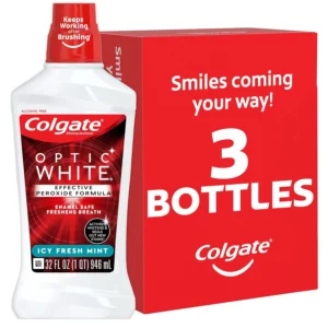 Three bottles of Colgate Optic White mouthwash featuring a 2% hydrogen peroxide formula to actively whiten teeth, prevent future stains with WhiteSeal technology, and kill bad breath germs, all in an alcohol-free, fresh mint formula.