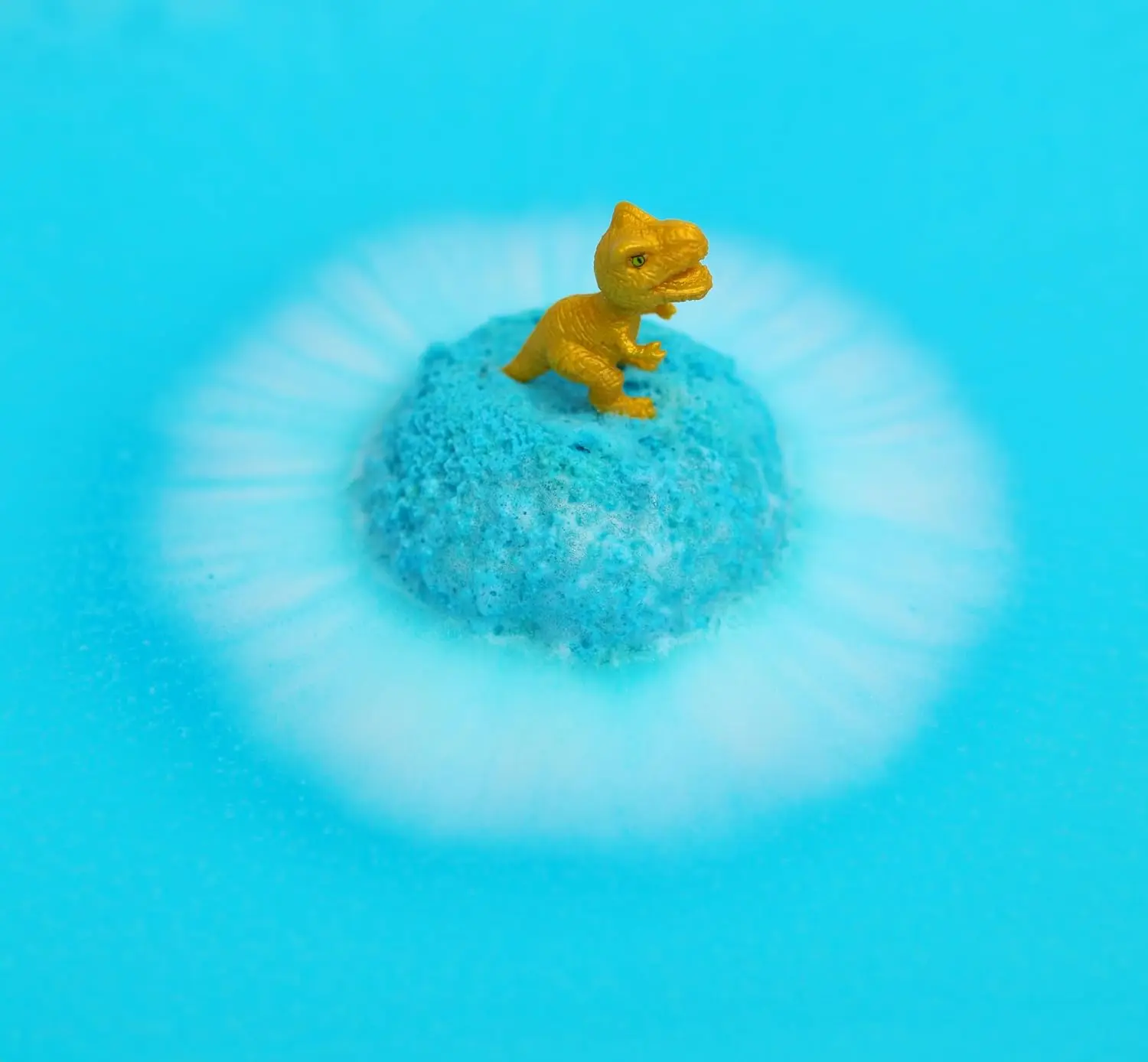 Six colorful Zimpli Kids bath bombs with surprise dinosaur toys inside, perfect as a fun and safe children's bath toy and birthday gift, made in the UK.